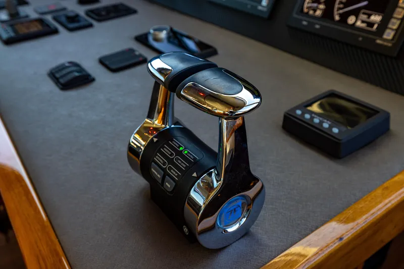 Slide: The Image of Control panel of 2022 Viking 54 Sport Coupe yacht with modern throttle levers. - 39