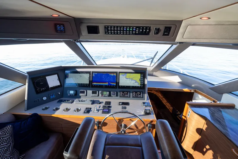 Slide: The Image of 2022 Viking 54 Sport Coupe helm with advanced navigation displays and luxurious interior. - 45