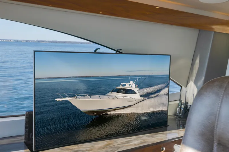 Slide: The Image of Interior view of 2022 Viking 54 Sport Coupe with ocean backdrop on screen. - 46