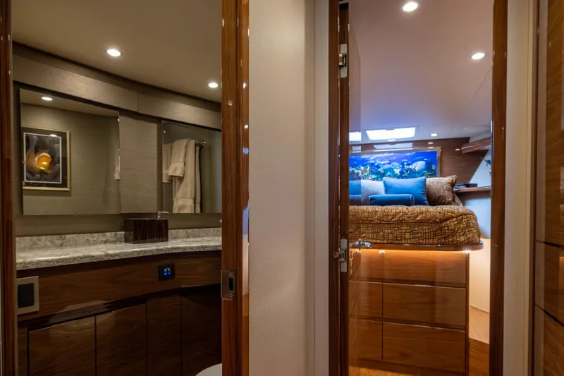 Slide: The Image of Luxurious interior of 2022 Viking 54 Sport Coupe yacht, featuring bedroom and bathroom. - 57