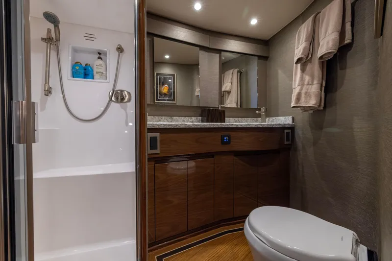 Slide: The Image of Luxurious bathroom in 2022 Viking 54 Sport Coupe yacht with modern fixtures and elegant design. - 58