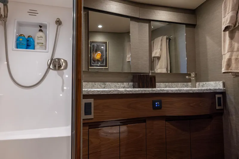 Slide: The Image of Luxurious bathroom in 2022 Viking 54 Sport Coupe yacht with modern fixtures and elegant design. - 59