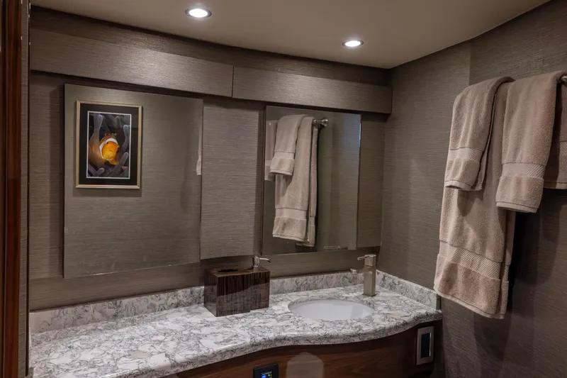 Slide: The Image of Luxurious bathroom in 2022 Viking 54 Sport Coupe with marble countertop and elegant decor. - 60