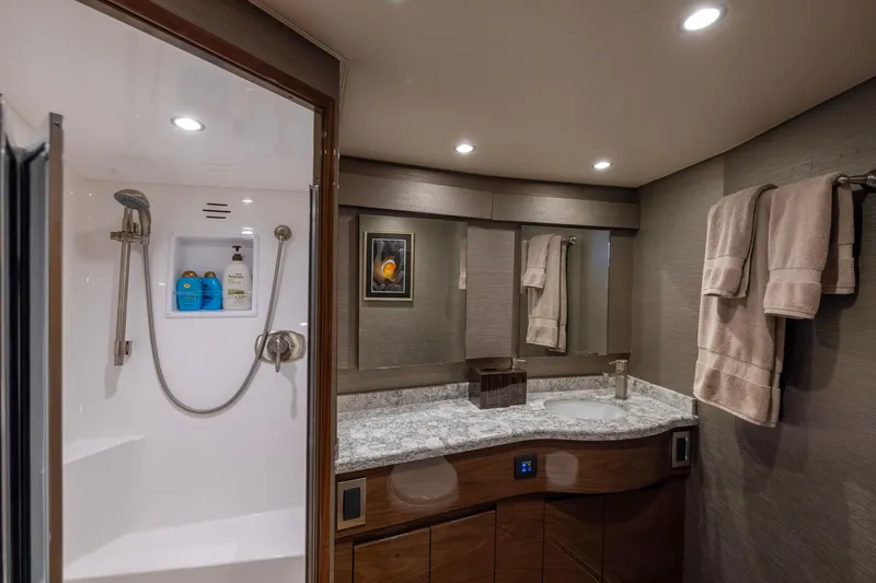 Slide: The Image of Luxurious bathroom in 2022 Viking 54 Sport Coupe yacht with modern shower and elegant vanity. - 61