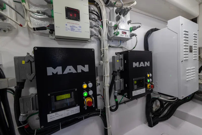 Slide: The Image of Engine room of 2022 Viking 54 Sport Coupe with MAN control panels and wiring. - 74