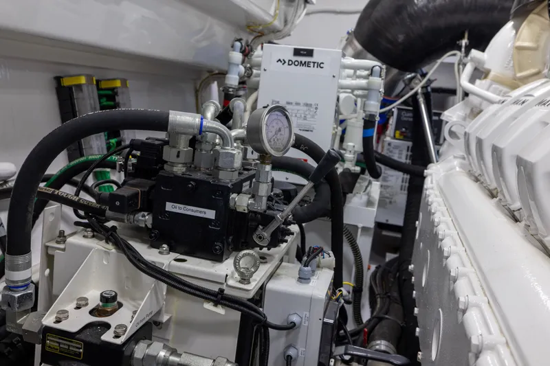 Slide: The Image of Engine room of 2022 Viking 54 Sport Coupe with Dometic system and hydraulic components. - 77