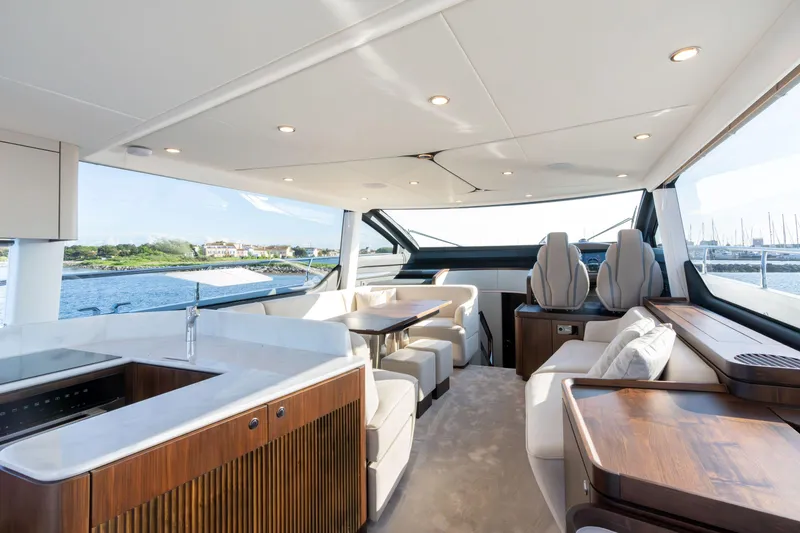 Slide: The Image of Luxurious interior of 2026 Fairline Squadron 58 yacht with elegant seating and panoramic windows. - 13
