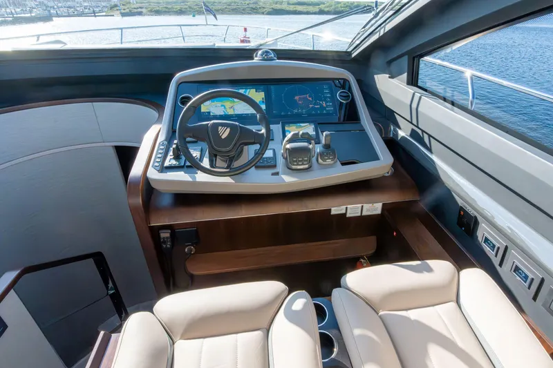 Slide: The Image of Helm of 2026 Fairline Squadron 58 yacht with modern navigation controls and leather seating. - 17