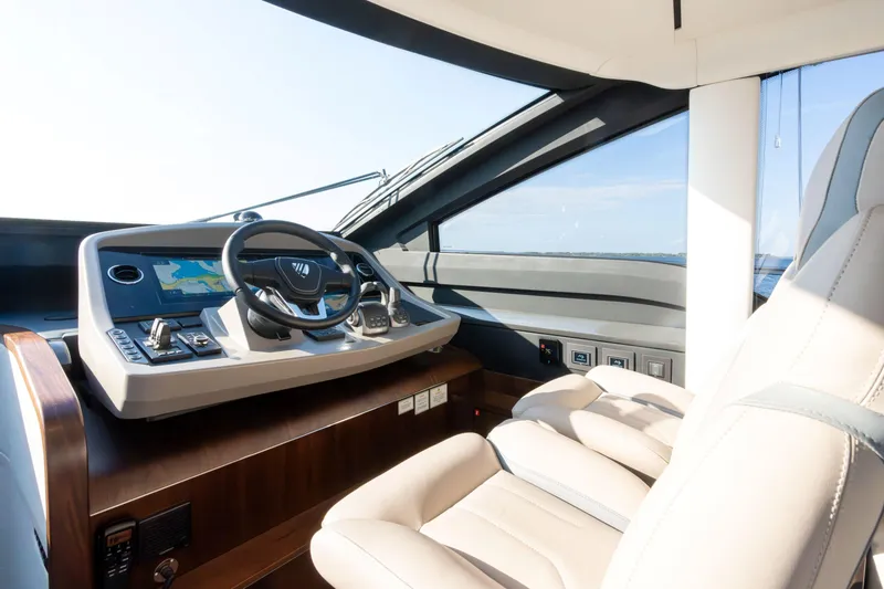 Slide: The Image of Luxurious helm of 2026 Fairline Squadron 58 yacht with modern controls and leather seating. - 18