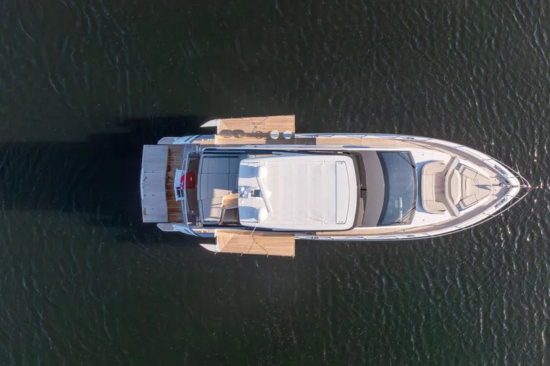 Slide: The Image of Aerial view of 2026 Fairline Squadron 58 yacht on calm water. - 2