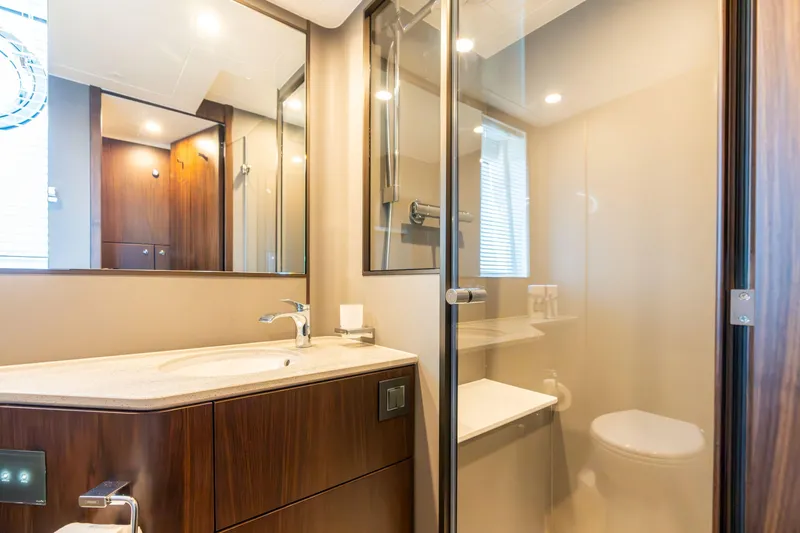 Slide: The Image of Luxurious bathroom in 2026 Fairline Squadron 58 yacht, featuring modern fixtures and elegant design. - 27