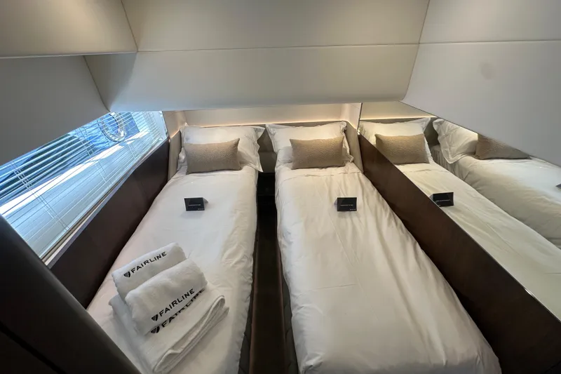Slide: The Image of Luxurious cabin interior of 2026 Fairline Squadron 58 yacht with twin beds and modern decor. - 29