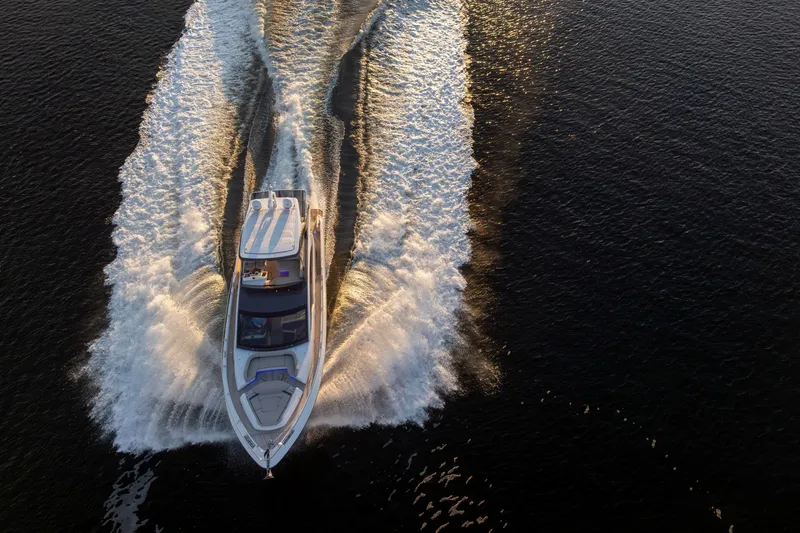 Slide: The Image of 2026 Fairline Squadron 58 yacht cruising on open water at sunset. - 3