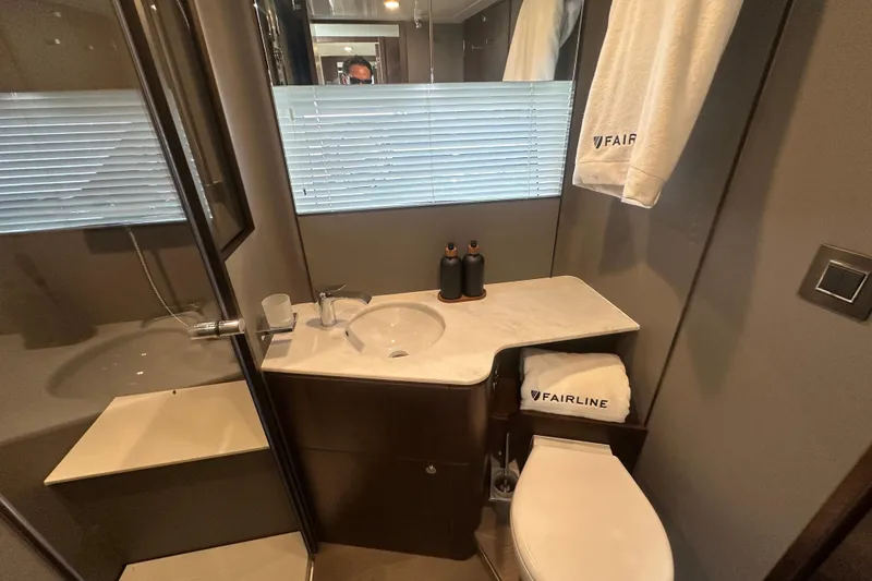 Slide: The Image of Luxurious bathroom in 2026 Fairline Squadron 58 yacht with modern fixtures and elegant design. - 37