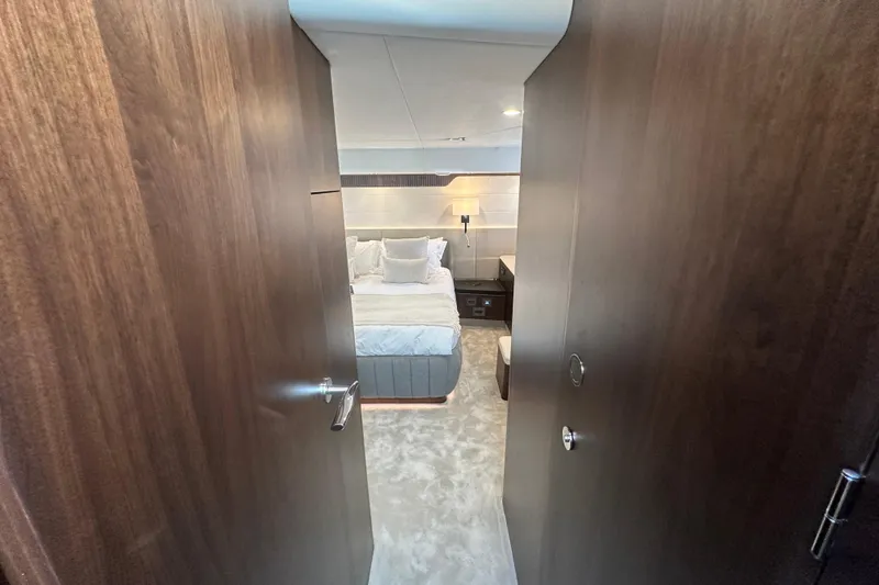Slide: The Image of Luxurious bedroom interior of 2026 Fairline Squadron 58 yacht, featuring elegant bedding and ambient lighting. - 39