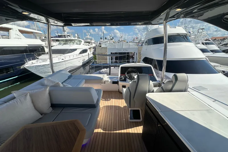 Slide: The Image of Luxurious 2026 Fairline Squadron 58 yacht cockpit with modern seating and steering wheel. - 56