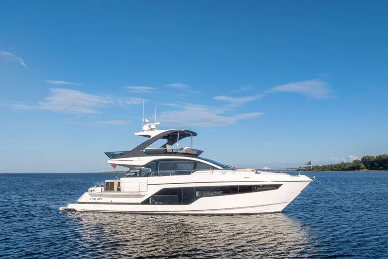 Slide: The Image of 2026 Fairline Squadron 58 yacht on calm blue water under clear sky. - 6
