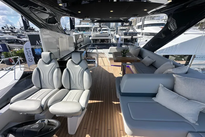 Slide: The Image of Luxurious 2026 Fairline Squadron 58 yacht with spacious deck seating under a sunny sky. - 65