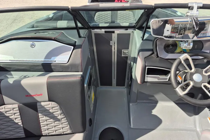 Slide: The Image of 2022 MasterCraft X24 boat interior with modern dashboard and steering wheel design. - 12