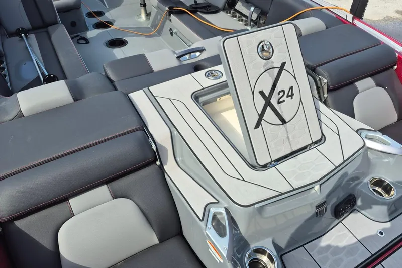Slide: The Image of 2022 MasterCraft X24 boat interior with sleek seating and storage compartment. - 20