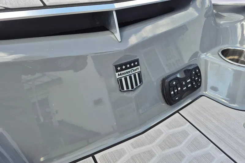 Slide: The Image of 2022 MasterCraft X24 boat with logo and control panel on gray surface. - 21
