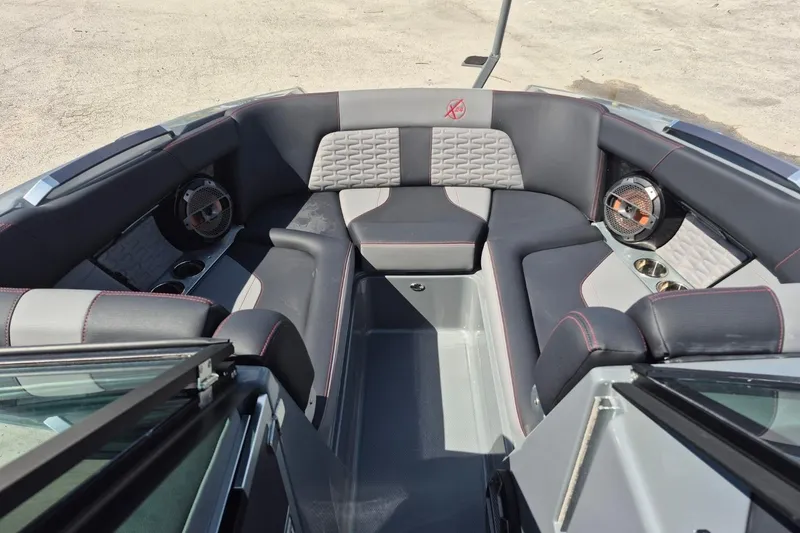 Slide: The Image of 2022 MasterCraft X24 boat interior with luxurious seating and premium audio system. - 24