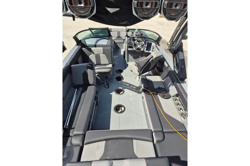 Slide: The Image of 2022 MasterCraft X24 boat interior with modern seating and audio system. - 25