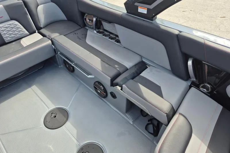 Slide: The Image of 2022 MasterCraft X24 boat interior with gray seating and cup holders. - 31