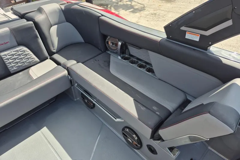 Slide: The Image of 2022 MasterCraft X24 boat interior with gray seating and cup holders. - 35