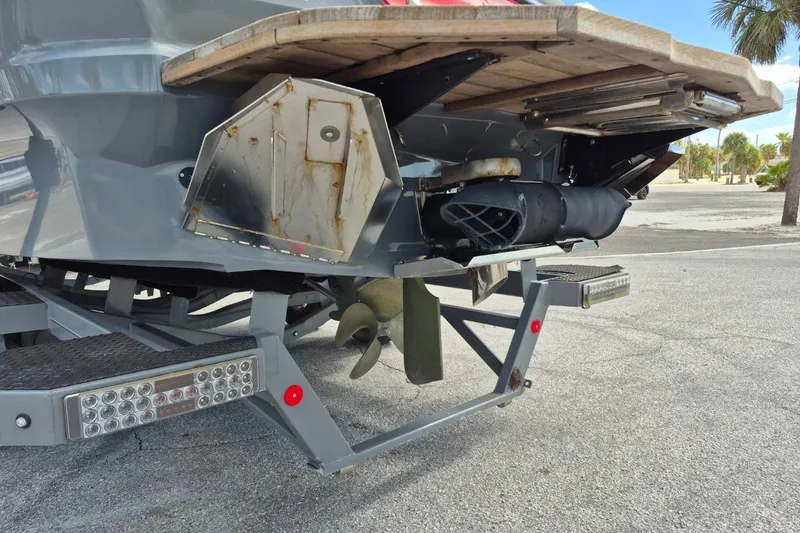 Slide: The Image of Rear view of 2022 MasterCraft X24 boat on trailer, showing propeller and exhaust system. - 5