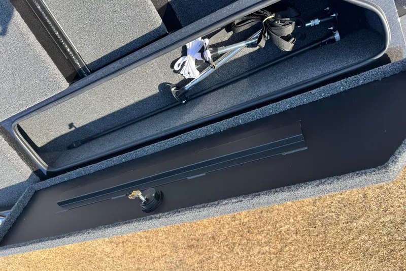 Slide: The Image of Open storage compartment of 2026 Vexus Defender 181 boat, showing equipment and accessories. - 12