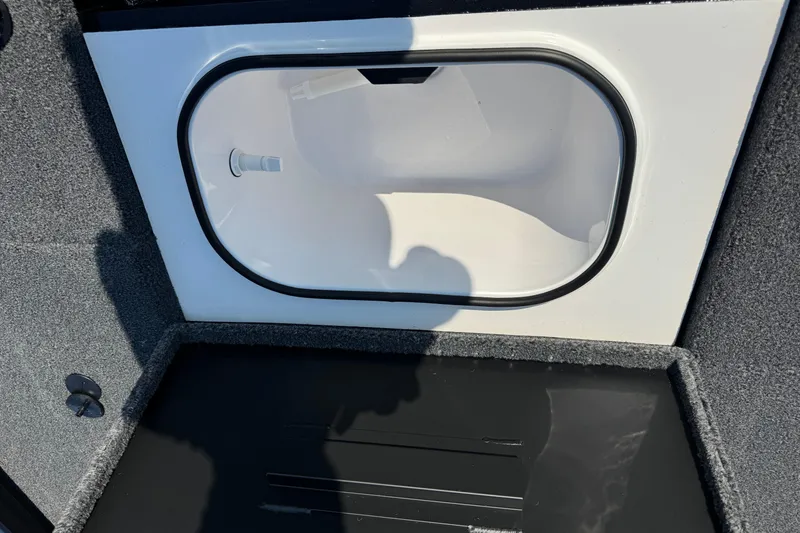Slide: The Image of Open storage compartment in 2026 Vexus Defender 181 boat, featuring a white interior. - 13