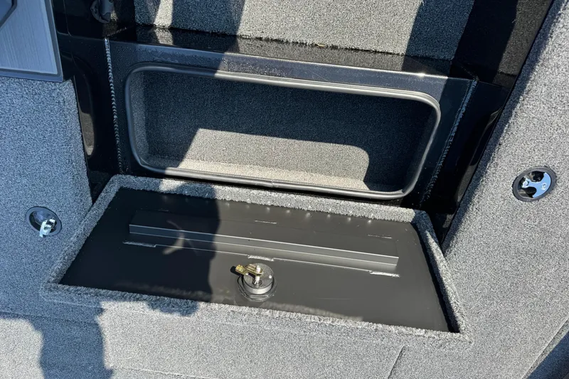 Slide: The Image of Interior storage compartment of 2026 Vexus Defender 181 boat, featuring secure lock mechanism. - 14