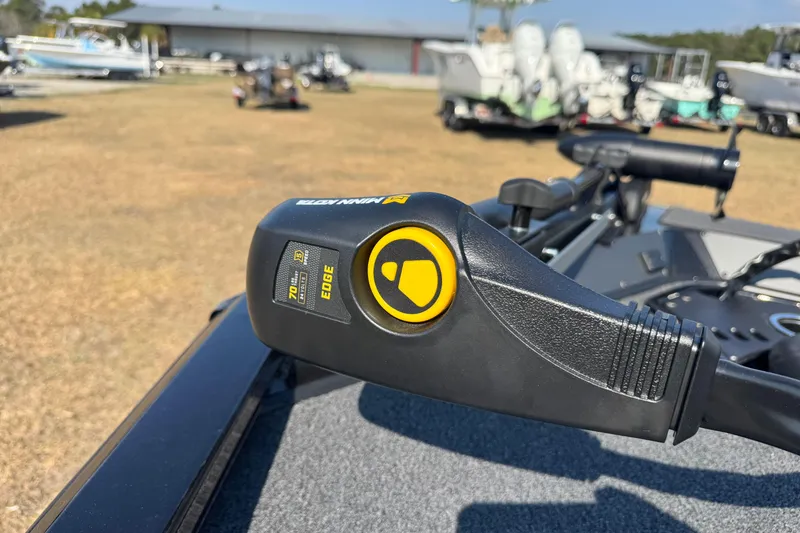 Slide: The Image of Trolling motor on 2026 Vexus Defender 181 boat, outdoor setting with other boats. - 16