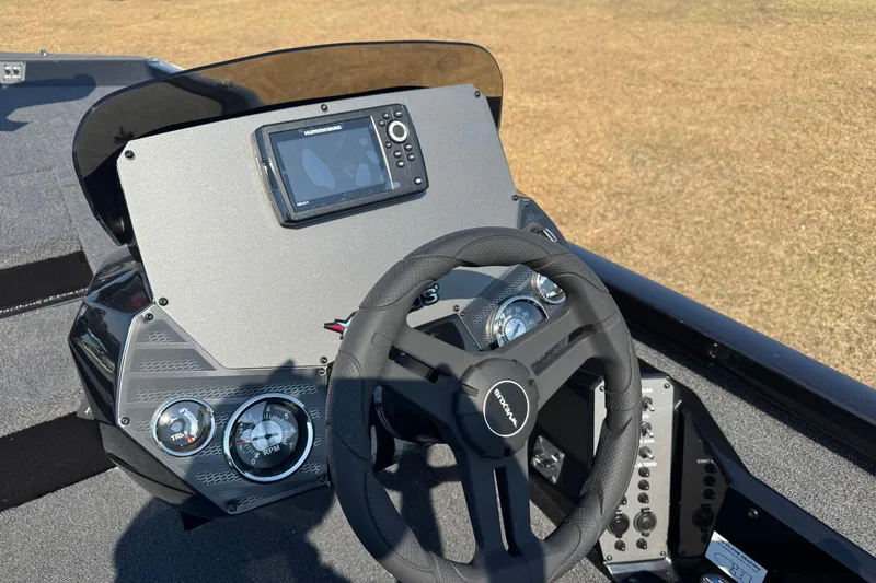 Slide: The Image of 2026 Vexus Defender 181 boat dashboard with steering wheel and navigation display. - 22