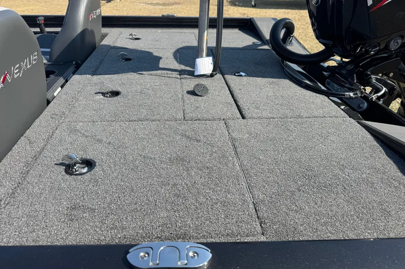 Slide: The Image of 2026 Vexus Defender 181 boat deck with carpeted surface and seating. - 28