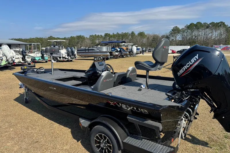 Slide: The Image of 2026 Vexus Defender 181 boat with Mercury engine, displayed outdoors on grass. - 3