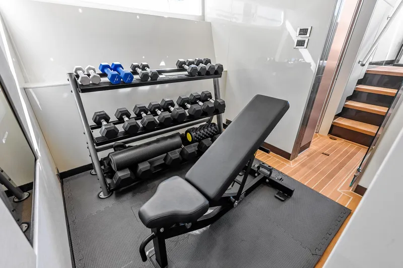 Slide: The Image of Home gym with weights and bench on Ocean Alexander 35 Revolution yacht, 2024 model. - 40