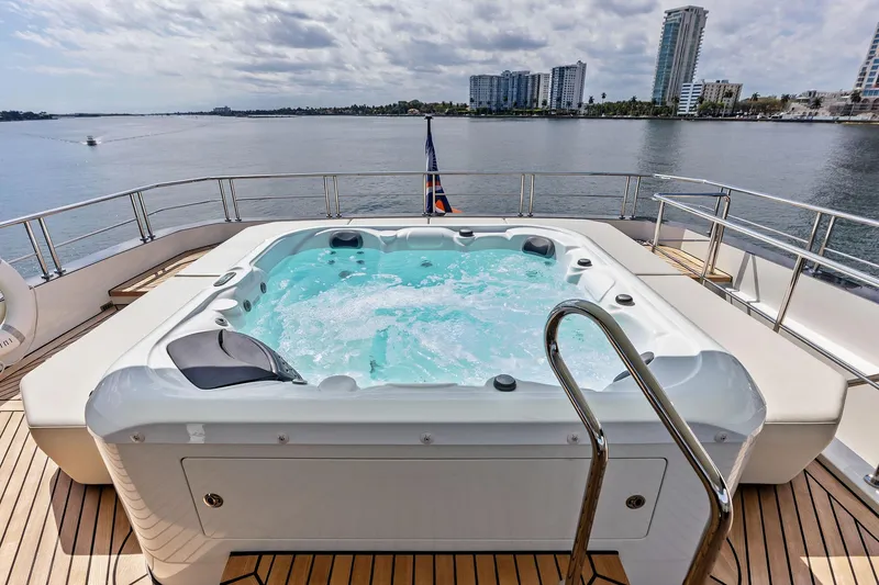 Slide: The Image of Luxury yacht Ocean Alexander 35 Revolution 2024 with jacuzzi on deck, overlooking waterfront skyline. - 8