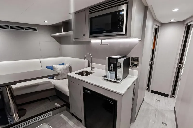 Slide: The Image of Luxurious interior of 2024 Ocean Alexander 35 Revolution yacht with modern kitchenette and seating area. - 60