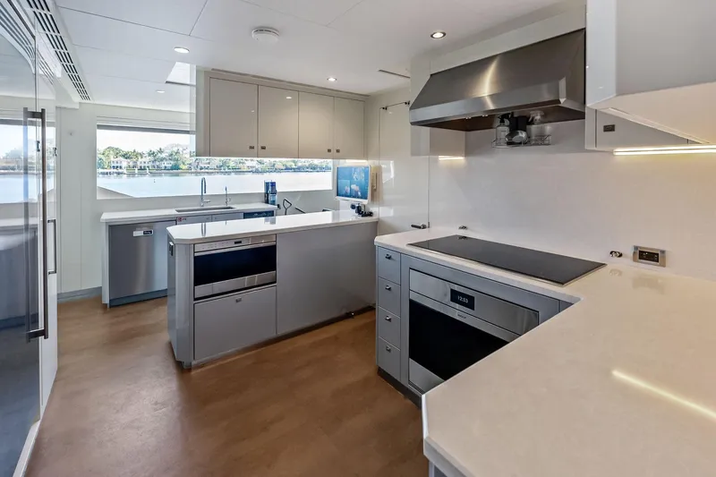Slide: The Image of Modern kitchen interior on 2024 Ocean Alexander 35 Revolution yacht, featuring sleek appliances and spacious design. - 37