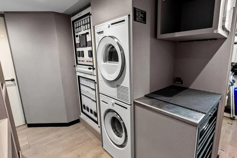 Slide: The Image of Laundry area with stacked washer and dryer in 2024 Ocean Alexander 35 Revolution yacht. - 69