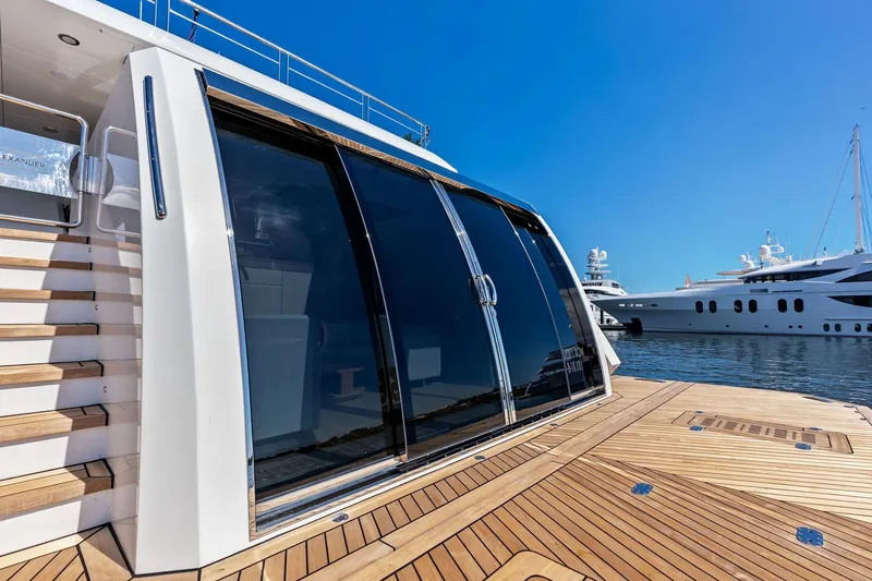 Slide: The Image of 2024 Ocean Alexander 35 Revolution yacht with sleek design and wooden deck, docked in marina. - 23
