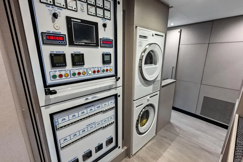 Slide: The Image of 2024 Ocean Alexander 35 Revolution yacht interior with control panel and laundry appliances. - 66