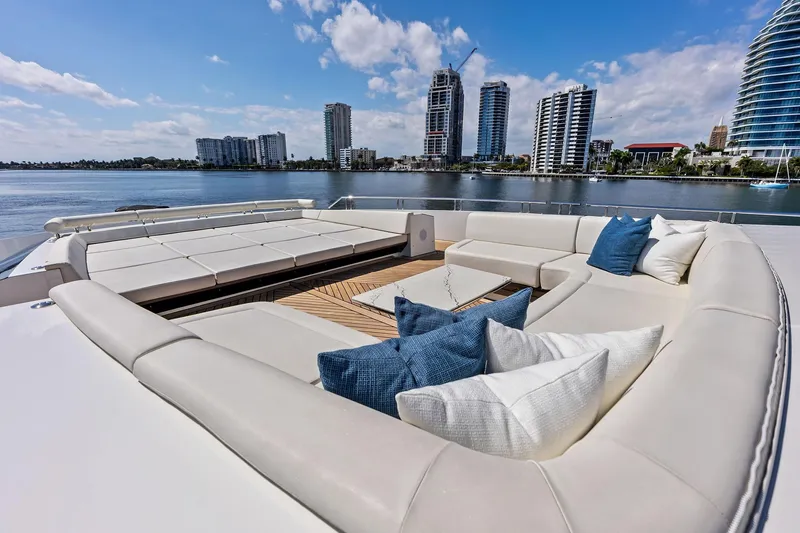 Slide: The Image of Luxurious 2024 Ocean Alexander 35 Revolution yacht deck with plush seating and scenic waterfront view. - 19