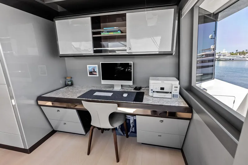 Slide: The Image of Modern office space on 2024 Ocean Alexander 35 Revolution yacht with desk, computer, and ocean view. - 29