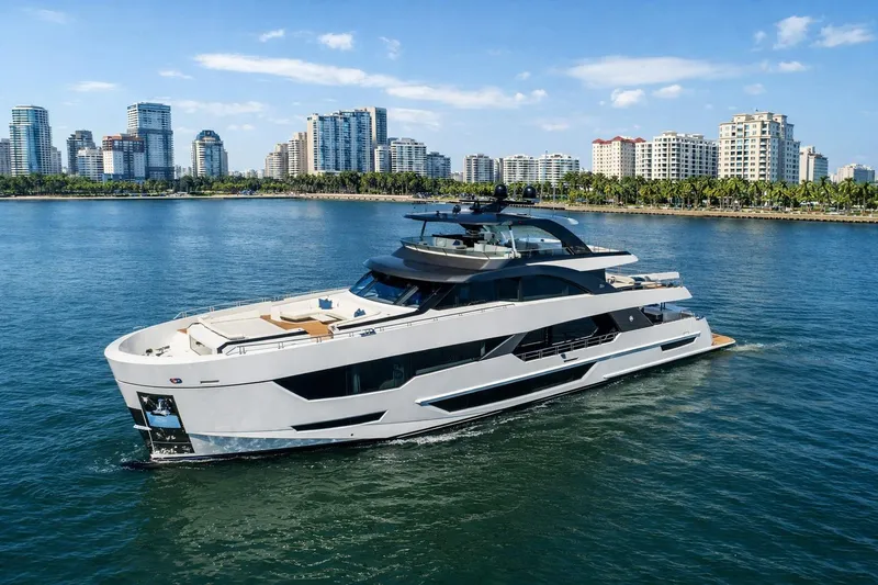 Slide: The Image of Luxury 2024 Ocean Alexander 35 Revolution yacht cruising near city skyline. - 1
