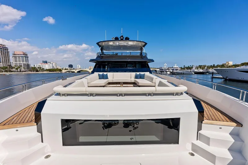 Slide: The Image of 2024 Ocean Alexander 35 Revolution yacht with luxurious deck seating, docked in a marina. - 18