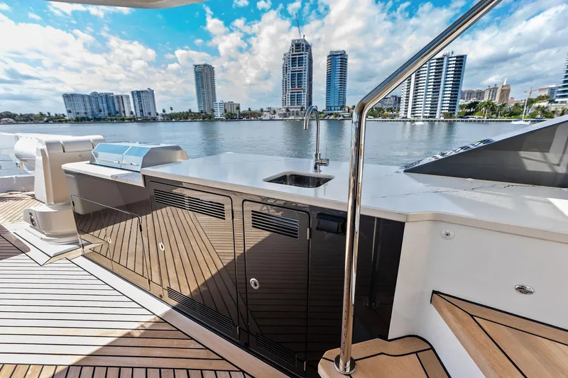 Slide: The Image of Luxurious 2024 Ocean Alexander 35 Revolution yacht deck with modern amenities and city skyline view. - 13