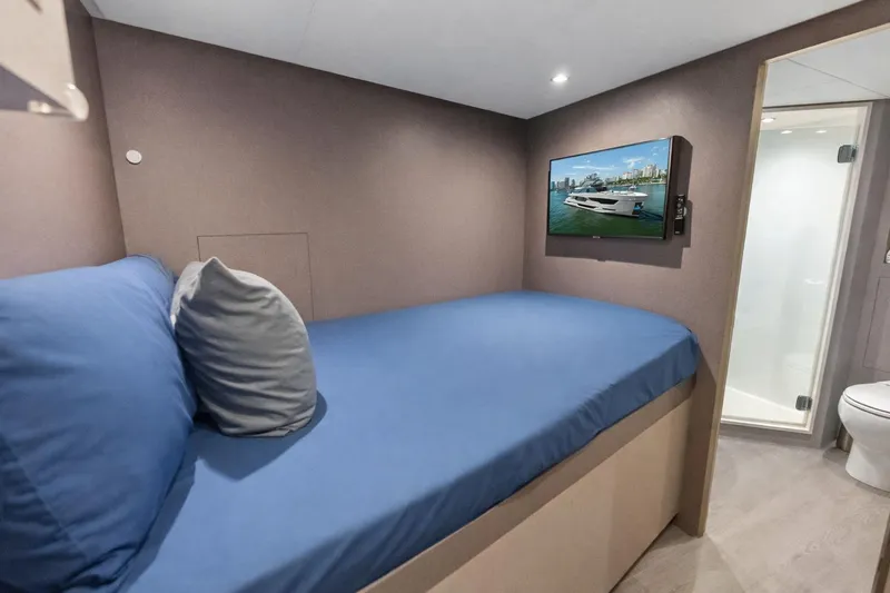 Slide: The Image of 2024 Ocean Alexander 35 Revolution yacht cabin with bed, TV, and ensuite bathroom. - 64